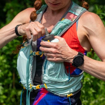 adjusting water bottle on hydration vest