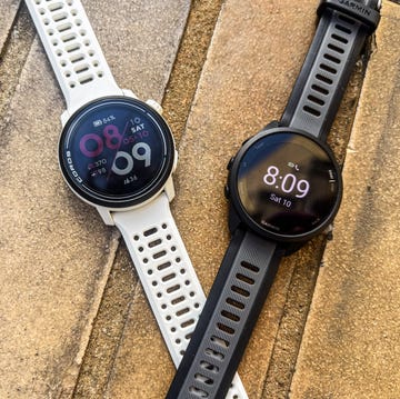 a pair of basic running watches on a textured surface
