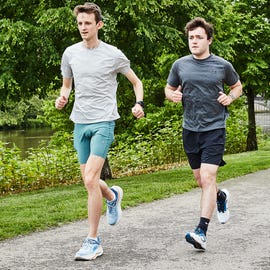 two men running on a gravel road