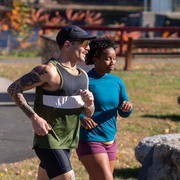 RWD Two individuals running in a park