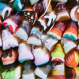 a pile of running shoes stacked on top of each other