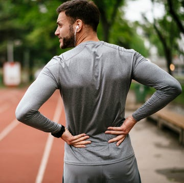 Sportsman suffering from backache at park outdoors sportsman suffering from backache at park outdoors